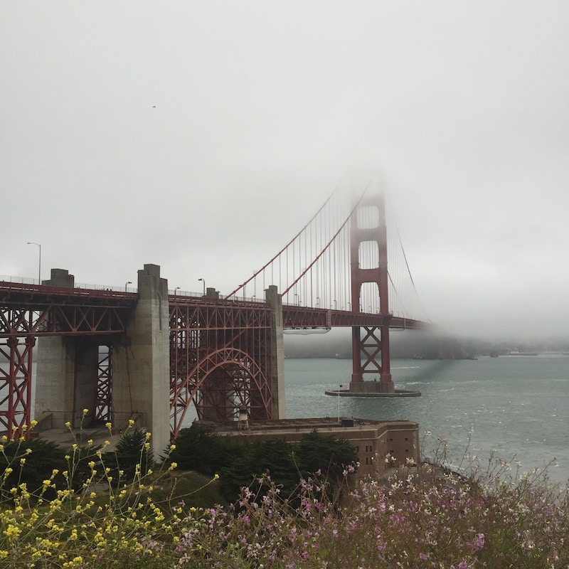 The Golden Gate Bridge partially hidden by clouds