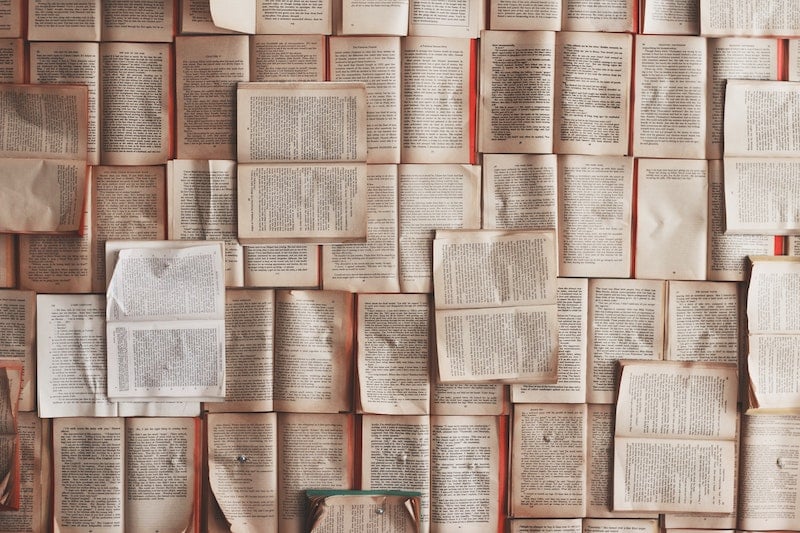 A wall of scattered pages from a book