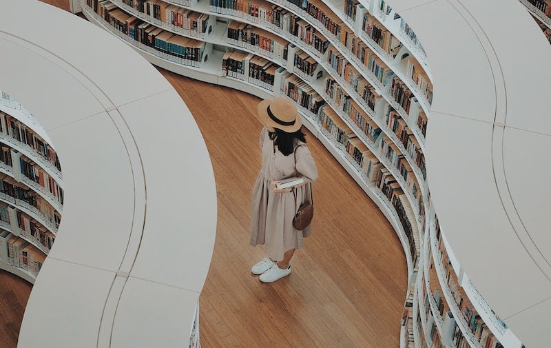 A woman stands in a library