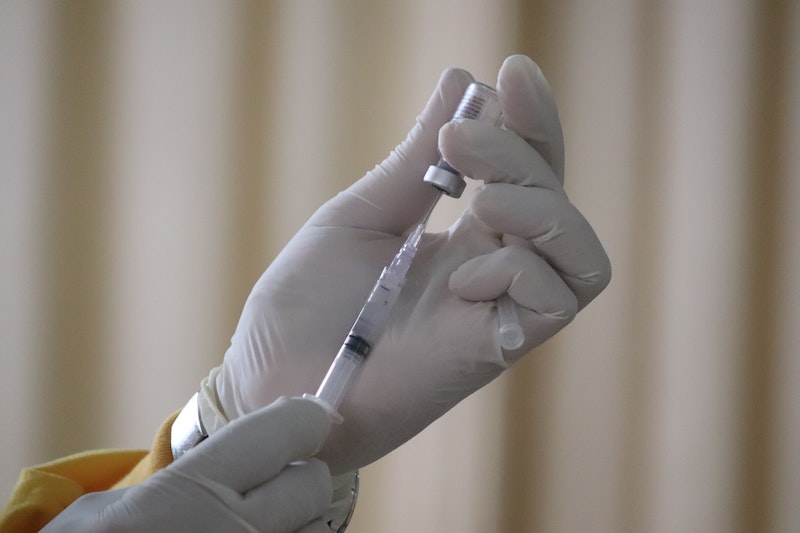 hands holding injection for vaccination